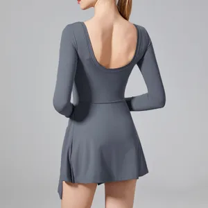 Back detail view of the long-sleeve athletic yoga jumpsuit, highlighting open back design.