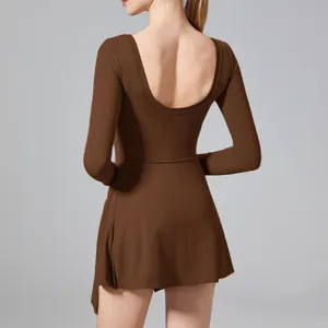 Brown athletic tennis dress with open back, long sleeves, and built-in shorts for active workouts.