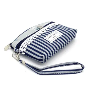 Blue white striped fabric coin purse detail showing lace trim and double zipper closure.