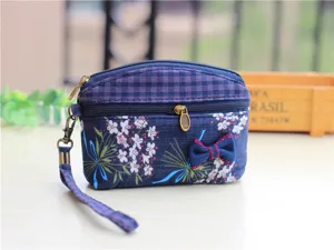 Floral fabric coin purse with double zippers, wrist strap, and cute bow for women use