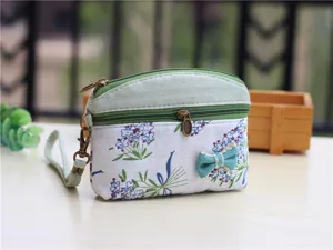 Floral fabric coin purse with dual zippers and wrist strap, cute pastoral style pouch.