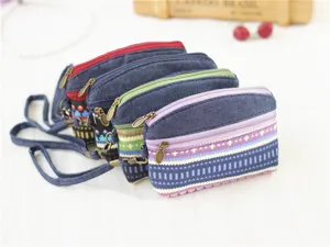 Retro canvas coin purse featuring double zippers, ethnic geometric pattern and strap.