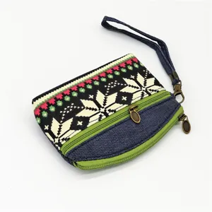 Detailed view of the ethnic style woven coin purse featuring denim fabric and double zippers.