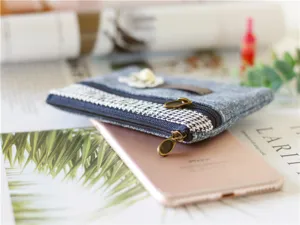 Denim coin purse detail shot showing double zippers, houndstooth pattern, and pearl flower decor.
