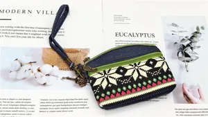 Ethnic style denim canvas coin purse with dual zippers, wrist strap and geometric pattern.