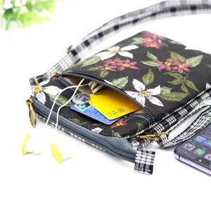Floral print canvas crossbody phone bag with multi-layer storage and plaid strap for women.