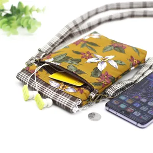 Floral print cotton crossbody cell phone bag with multiple zipper compartments and straps.