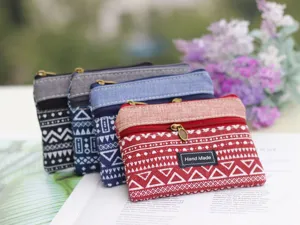 Close-up detail of geometric printed cotton linen coin purse with double zipper design.
