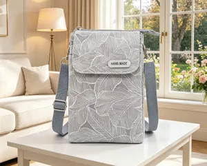 Grey leaf print canvas crossbody phone bag with adjustable strap and multi-layer design.