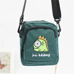 Green nylon crossbody bag featuring cute cartoon monster embroidery and adjustable shoulder strap.