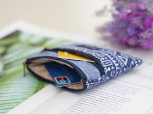 Detail shot of a cotton linen coin purse with ethnic geometric print and double zipper design.