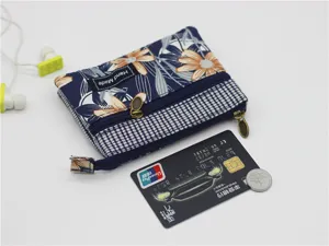 Floral cotton coin purse with multiple layers, double zippers and a cute handmade fabric tag.