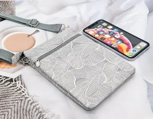 Leaf print fabric crossbody phone bag with multi-layer zipper and adjustable strap.