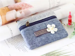 Detailed view of the cute blue fabric coin purse with houndstooth and floral decor.