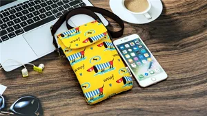 Yellow waterproof crossbody phone bag with cute dog print, brown strap and detail view.