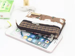 Detailed view of a multi-layer cotton coin purse with floral pattern and zipper pockets.