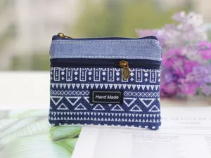 Detail view of the blue geometric cotton linen coin purse zipper pouch with handmade label.