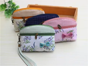 Fabric coin purse with double zippers, cute floral pattern and wrist strap for daily use.