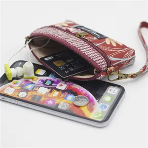 Fabric coin purse with floral pattern, double zippers and wrist strap for daily use.