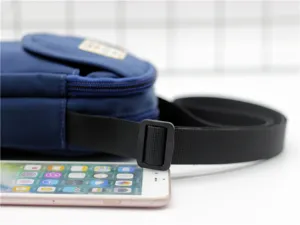 Dettaglio borsa a tracolla per cellulare in nylon blu con cinturino nero regolabile.