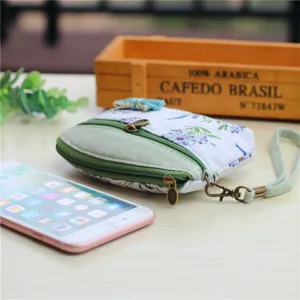 Floral canvas coin purse with dual zippers and wrist strap, compact pouch for keys and change.