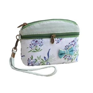 Korean style floral fabric coin purse with double zipper, cute bow and handy wrist strap.