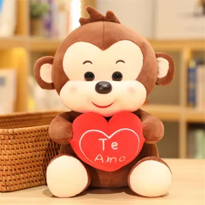 Detailed view of cute brown plush monkey toy holding a red heart with romantic love embroidery.