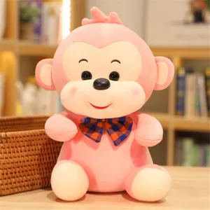 Cute pink plush monkey toy with a stylish bow tie, soft stuffed doll gift for children.