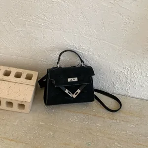 Classic black suede handbag with chic metal lock closure, perfect for stylish wear.