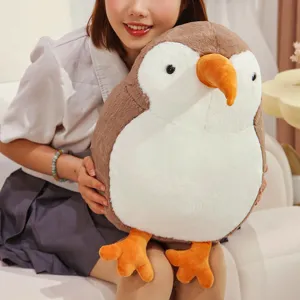 Detailed shot of the cute kiwi bird plush toy held by a model, soft fabric and fluffy design.