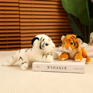 Detailed shot of cute simulation tiger plush toys lying on a book prop in a cozy indoor setting.