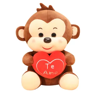 Cute brown plush monkey stuffed toy holding a red heart with embroidery, perfect for gifting.