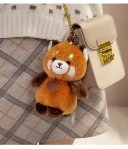 Cute red panda plush bag charm, soft stuffed animal keychain pendant for backpacks and handbags.