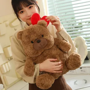 Detailed shot of the cute brown teddy bear plush toy with a red heart, soft and cuddly gift.