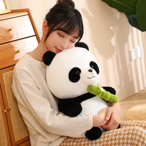 Detailed view of cute panda plush toy holding green bamboo, soft toy for kids gift.