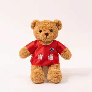 Adorable brown plush teddy bear wearing a red soccer jersey with Nantong printed. Soft toy gift.
