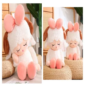 Cute sheep plush doll detail view, showing soft white fur texture, brown horns, and big pink bow.
