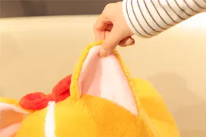 Close-up view of the soft plush toy ear featuring pink inner lining and a cute red bow detail.