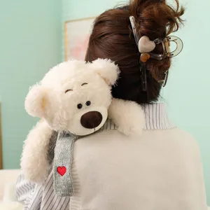 Plush teddy bear toy featuring a grey knitted scarf with red heart, cute plush gift.