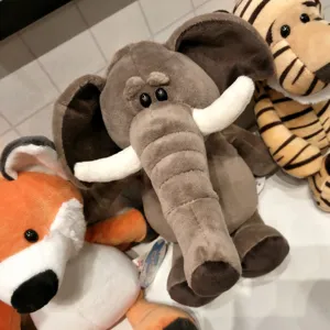 Cute plush animal toys detail closeup, soft stuffed elephant, tiger and fox for kids.