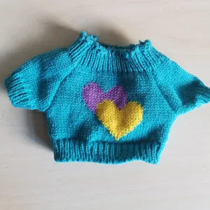 Handmade doll knitted sweater with cute heart patterns, perfect for plush toy clothing.
