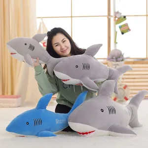 Detailed scene of soft cartoon shark plush toys in gray and blue, cute doll decor.