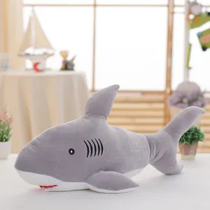 Grey plush shark toy detail showing soft fabric, embroidered text, and cute expression.