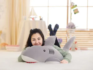 Detailed lifestyle shot of a cute gray shark plush toy skin with a cozy home setting.