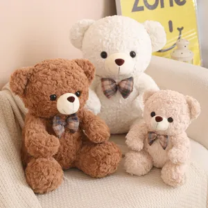 Detail view of cute plush teddy bears sitting together, featuring soft fluffy fur and bowties.