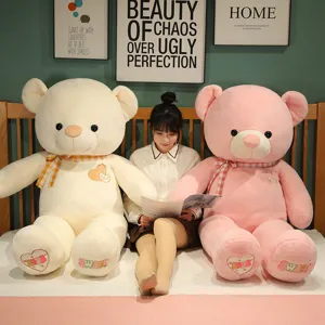 Giant plush teddy bear stuffed animal with heart embroidery, soft giant doll toy detail view.