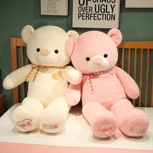 Detailed view of large plush teddy toy, soft stuffed animal with cute heart embroidery.