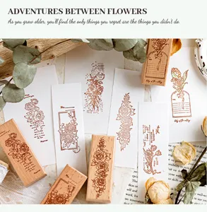 Detailed shot of vintage floral beech wood stamp with artistic stamped paper and flowers.