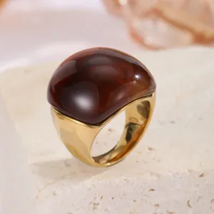 Anello massiccio placcato in oro con design a cabochon bombato marrone scuro, dettaglio.