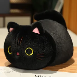 Close-up of cute black cat plush pillow detail, soft fabric and embroidered eyes.